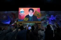 Lebanese watching an address by Hezbollah leader Sayyed Hassan Nasrallah, Beirut, April 2024. Mohamed Azakir / Reuters